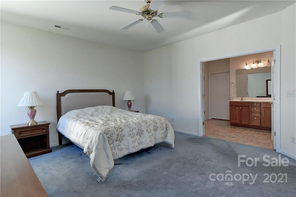 302 Garnet Court, Unit 522 Fort Mill, SC 29708 - Photo 23 of 45 a bedroom with a bed and a lamp