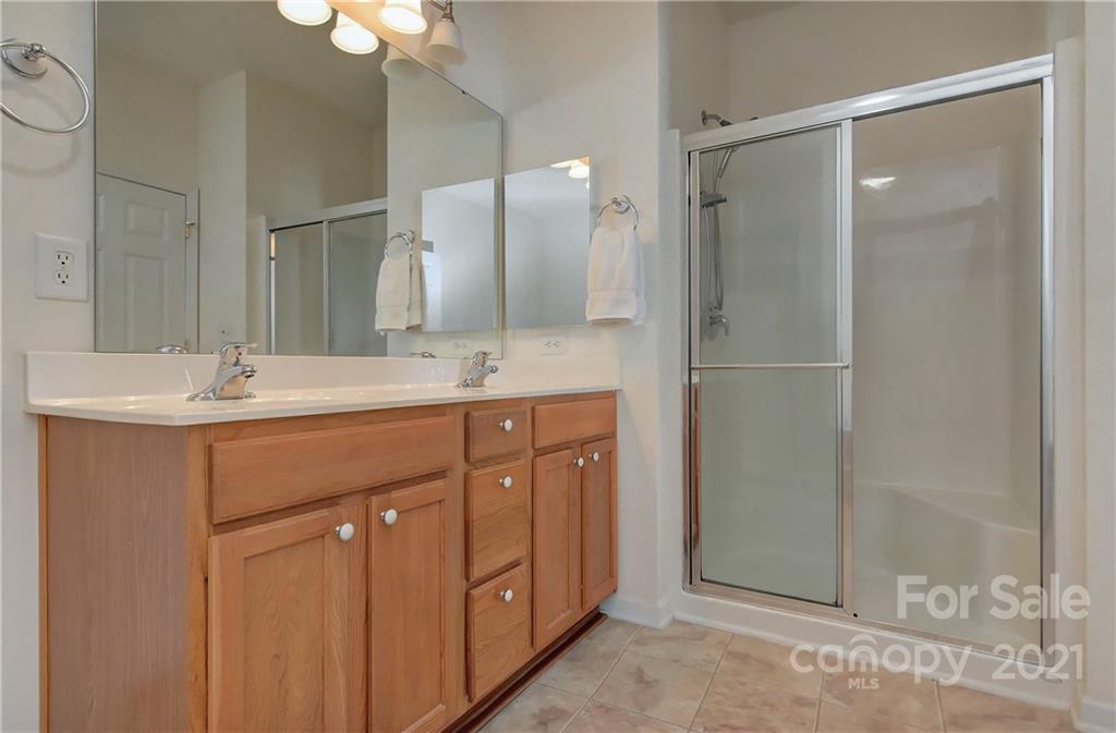 302 Garnet Court, Unit 522 Fort Mill, SC 29708 - Photo 24 of 45 a bathroom with a double vanity sink mirror and shower
