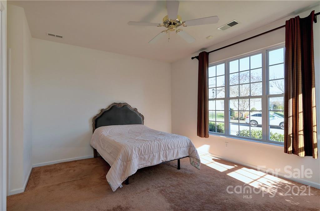 302 Garnet Court, Unit 522 Fort Mill, SC 29708 - Photo 26 of 45 a spacious bedroom with a bed and a large window