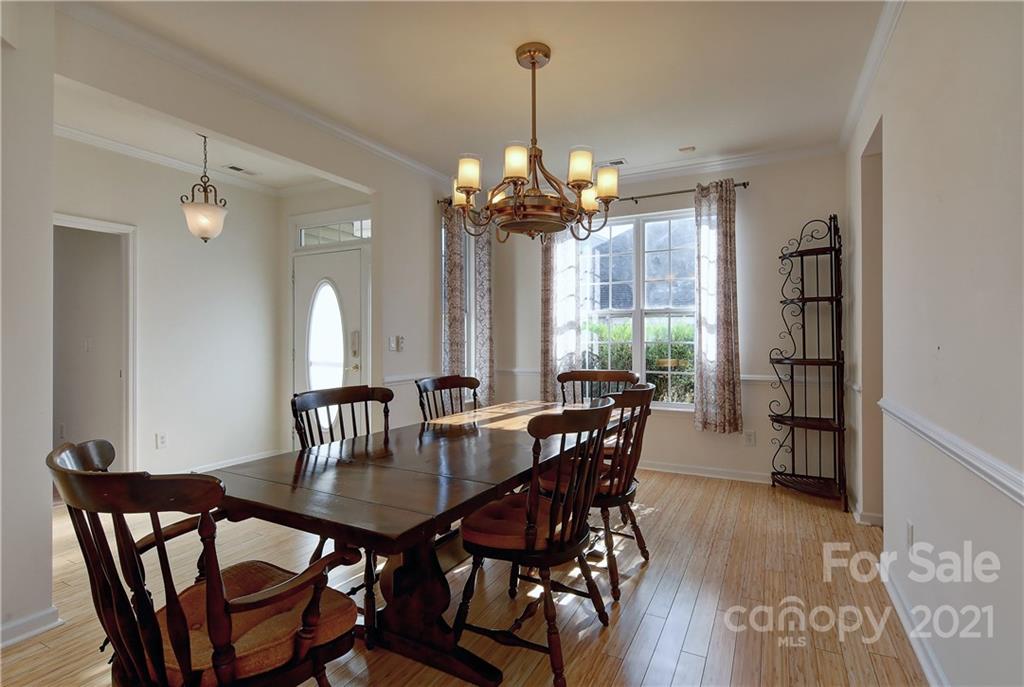 302 Garnet Court, Unit 522 Fort Mill, SC 29708 - Photo 8 of 45 a view of a dining room with furniture window and wooden floor