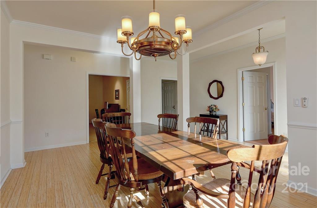 302 Garnet Court, Unit 522 Fort Mill, SC 29708 - Photo 10 of 45 a view of a dining room with furniture and chandelier