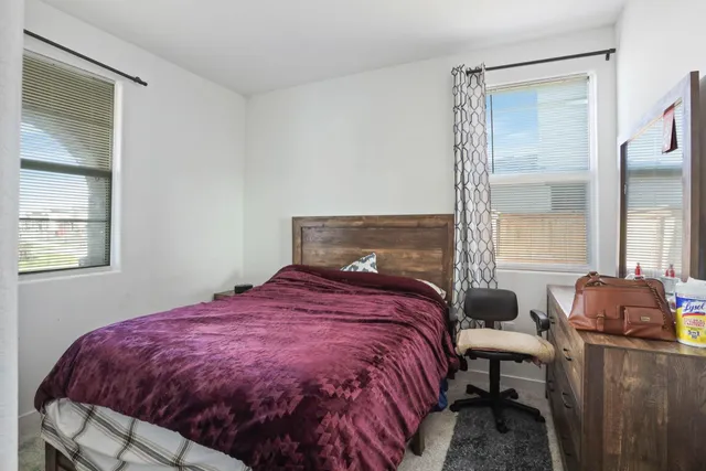 a bedroom with a bed and window