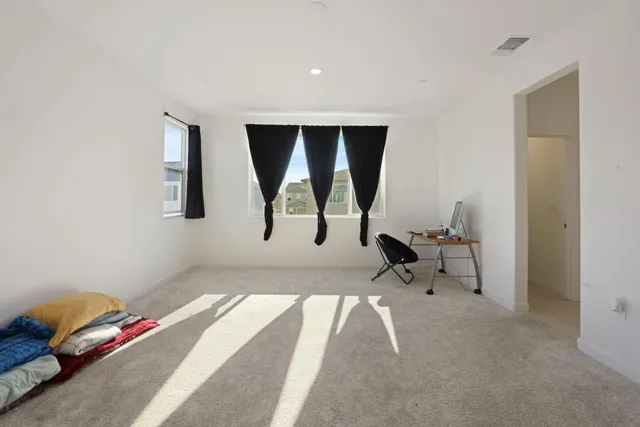 a view of a room with gym equipment and a window