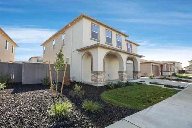 a front view of a house with garden