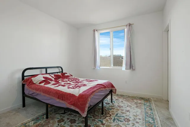 a bedroom with a bed and a window