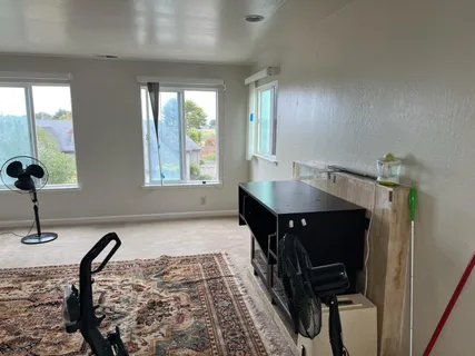 a view of a dining room with furniture and a window