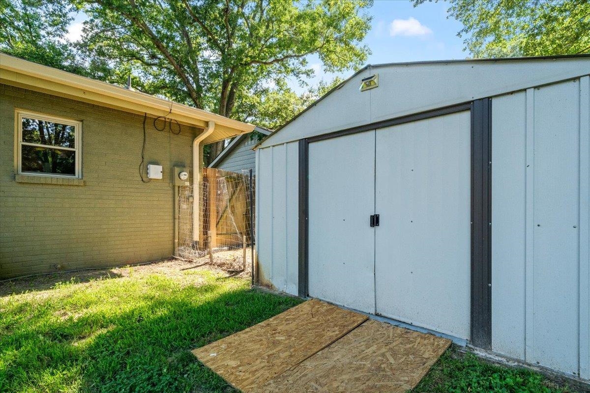 4686 Bill Knight Road Millington, TN 38053 - Photo 27 of 29 Metal storage shed with double doors and a gabled roofline