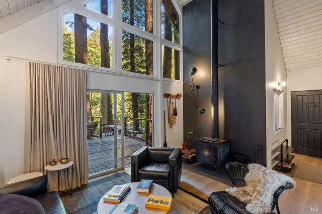 a living room with furniture and a floor to ceiling window