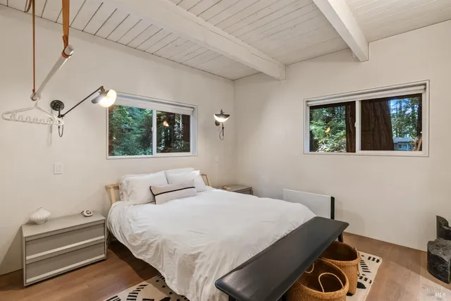 a bedroom with a bed and a painting on the wall