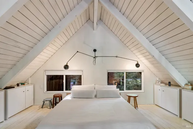 a view of a hallway with wooden floor and fence