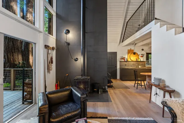 a living room with furniture and a floor to ceiling window