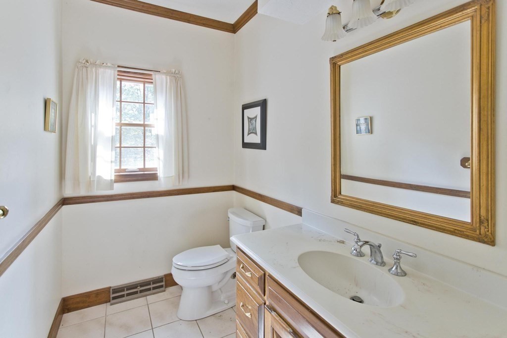 155 Edwards Road Westhampton, MA 01027 - Photo 25 of 39 a bathroom with a toilet sink vanity and mirror