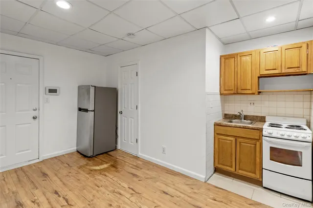 a kitchen with a stove a refrigerator and cabinets