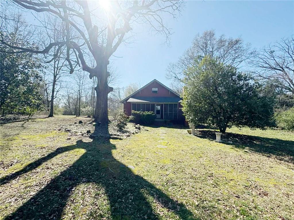 126 Birch Street Nicholson, GA 30565 - Photo 3 of 36 a yellow house with trees in front of it