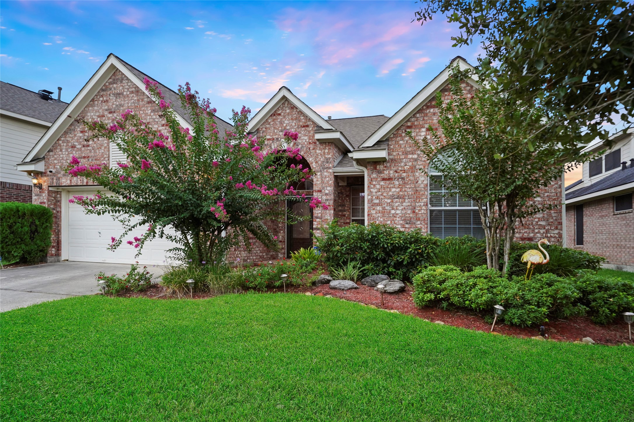 a front view of a house with a garden and plants