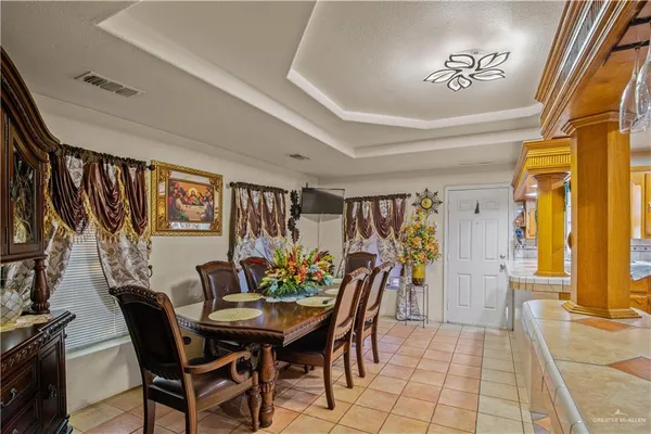 a view of a dining room with furniture and a potted plant