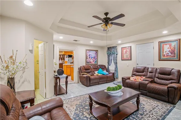 a living room with furniture and a ceiling fan