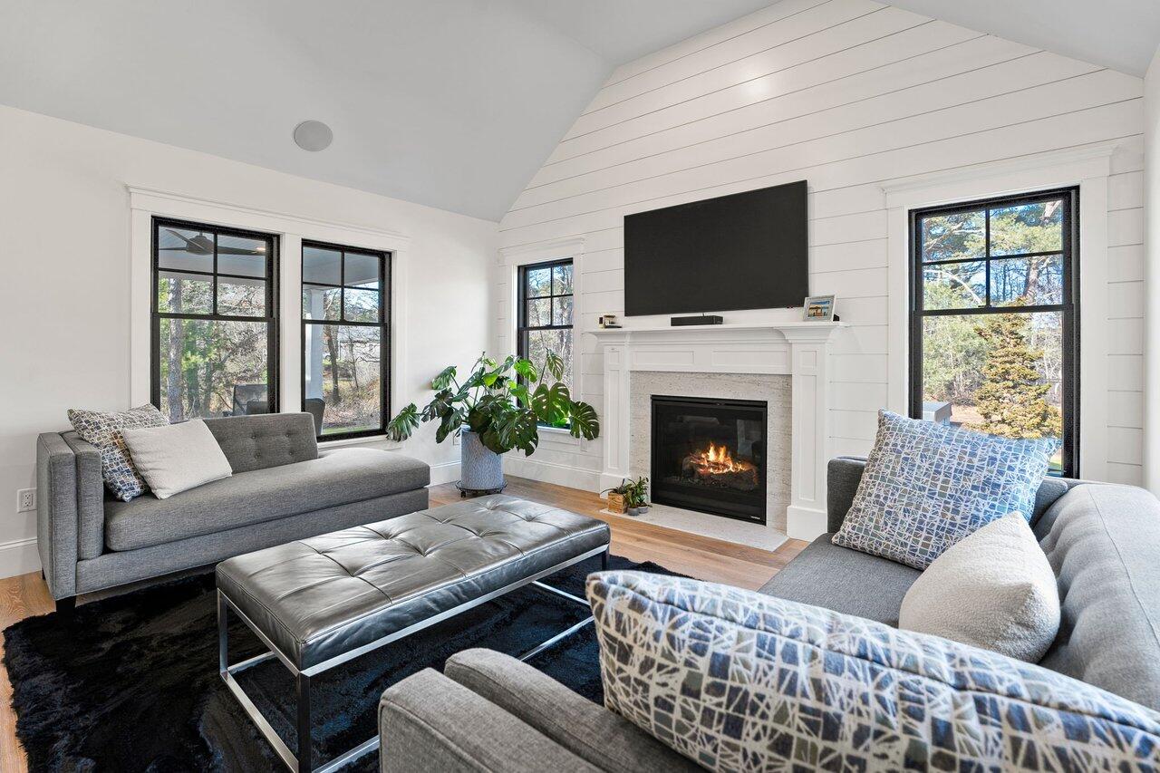 131 Old Barnstable Road Mashpee, MA 02649 - Photo 12 of 93 a living room with furniture a flat screen tv and a fireplace