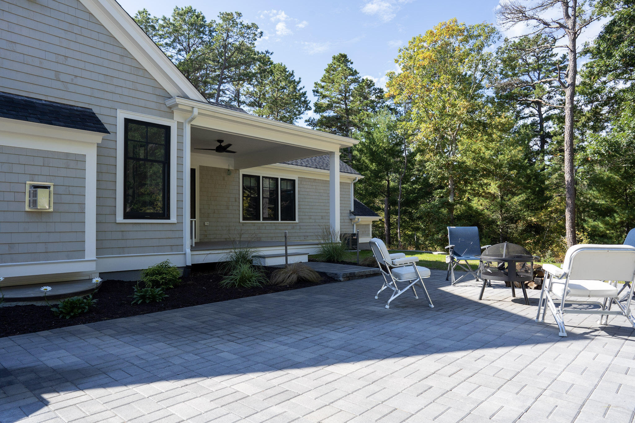 131 Old Barnstable Road Mashpee, MA 02649 - Photo 48 of 93 a view of a patio with table and chairs with wooden floor and fence