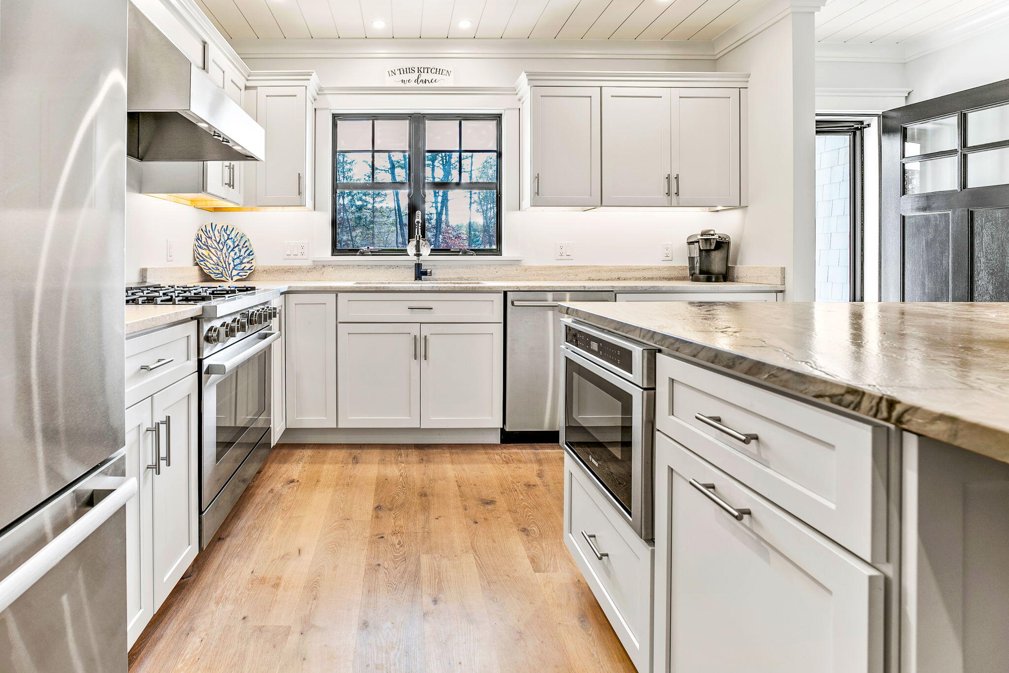 131 Old Barnstable Road Mashpee, MA 02649 - Photo 73 of 93 a kitchen with granite countertop a sink stainless steel appliances and white cabinets