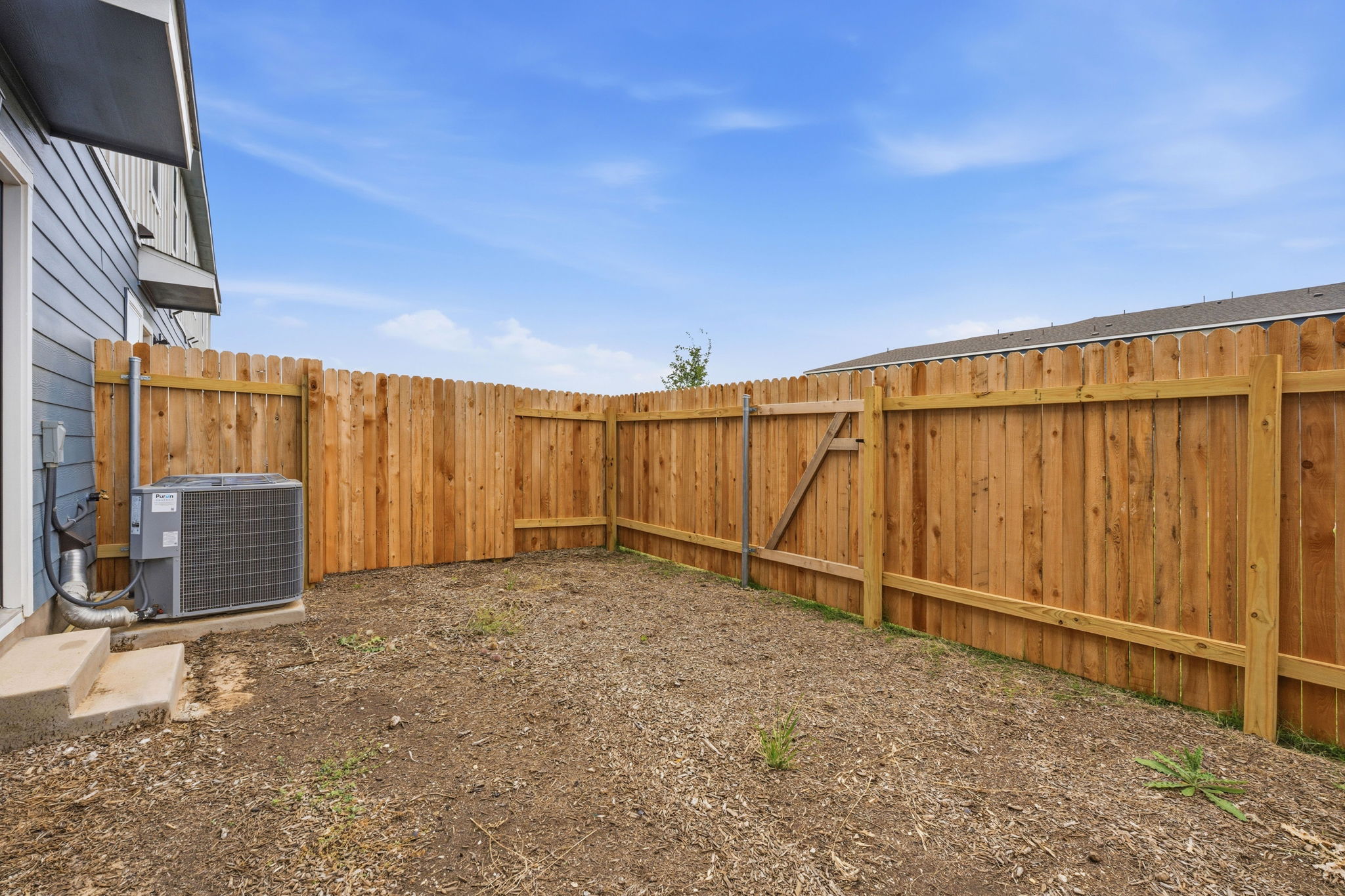164 Cinnabar Lane, Unit 2 Kyle, TX 78640 - Photo 20 of 21 Enclosed backyard featuring a new wood fence and a side gate