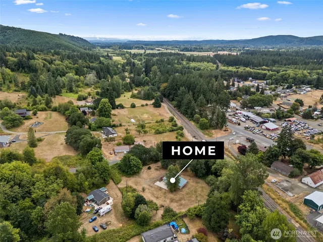 an aerial view of a city with lots of residential buildings and mountain view in back