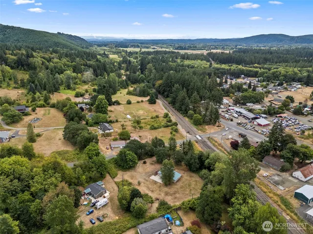 a view of a field with trees in the background