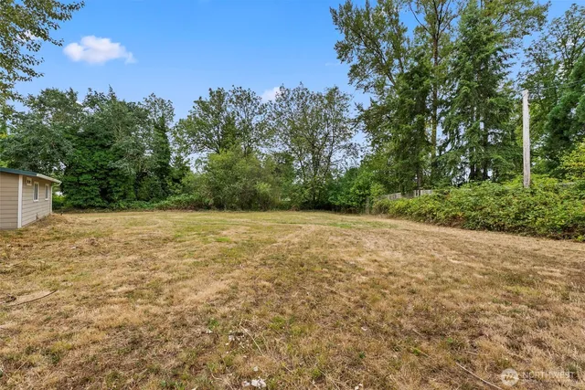 a street sign on a sidewalk next to a road