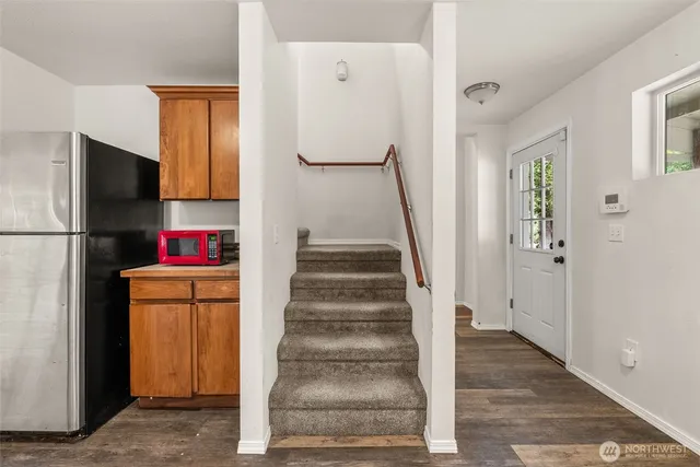 a view of entryway with furniture and wooden floor