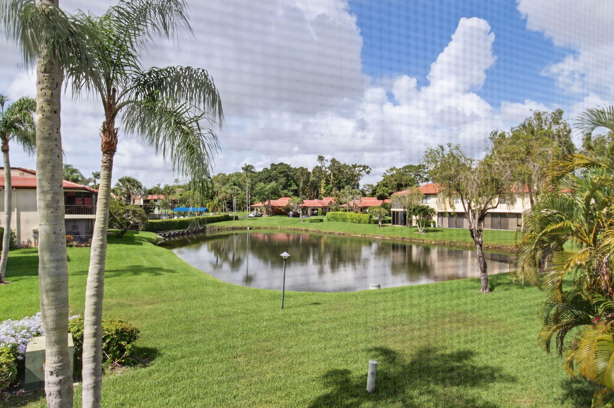 8536 Casa Del Lago, Unit 49B Boca Raton, FL 33433 - Photo 26 of 79 a view of a lake with a yard and large trees