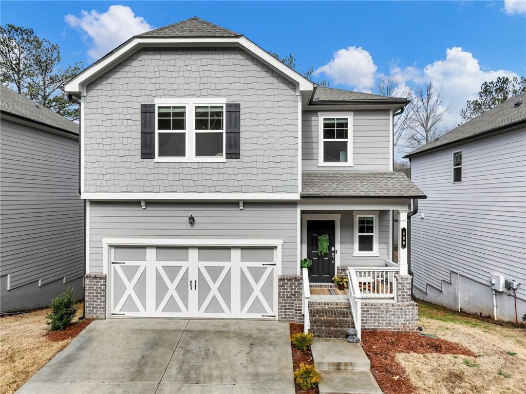 680 Groover Street Ball Ground, GA 30107 - Photo 1 of 42 a front view of a house with a garage