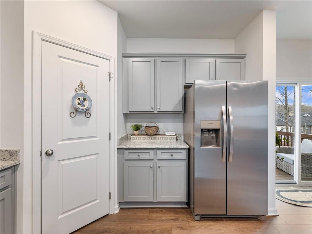 680 Groover Street Ball Ground, GA 30107 - Photo 13 of 42 a kitchen with stainless steel appliances granite countertop a refrigerator and a stove top oven