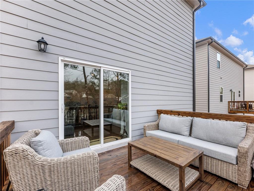 680 Groover Street Ball Ground, GA 30107 - Photo 17 of 42 a balcony with furniture and a potted plant