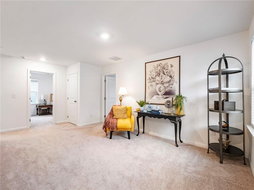 680 Groover Street Ball Ground, GA 30107 - Photo 18 of 42 a bedroom with furniture and a window