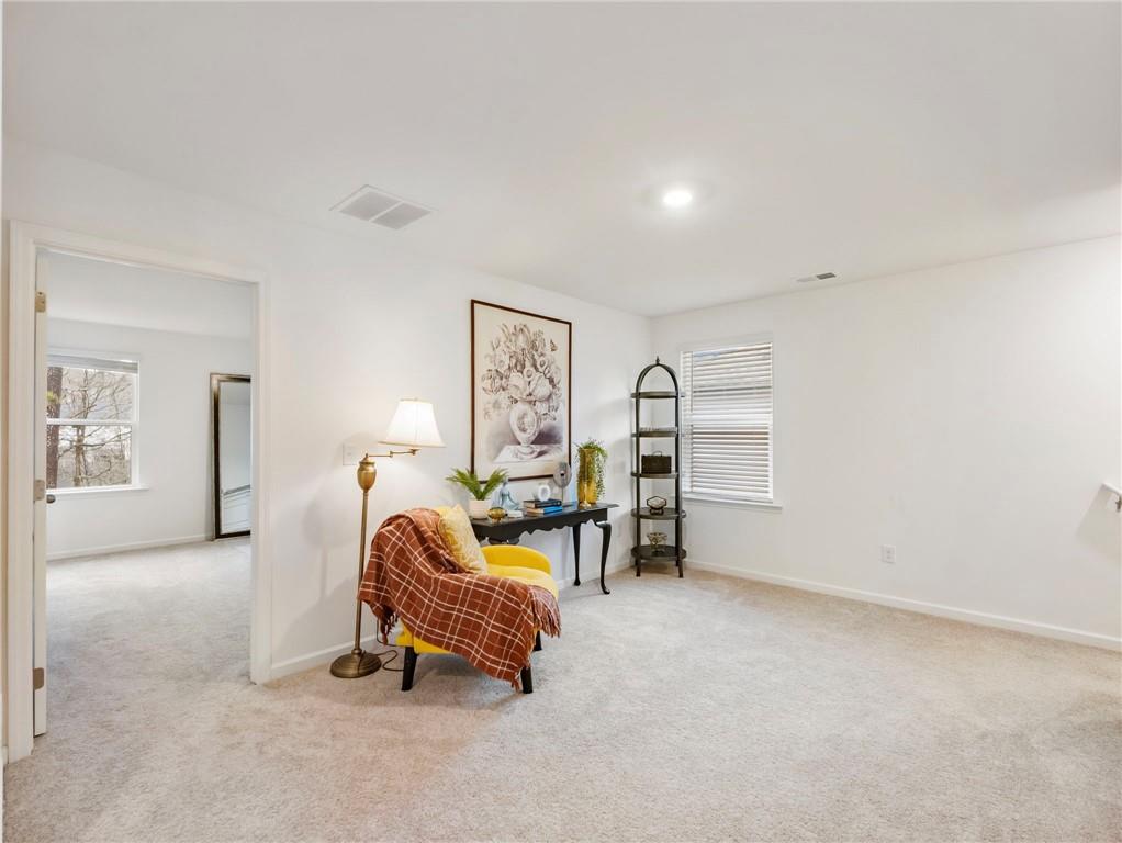 680 Groover Street Ball Ground, GA 30107 - Photo 19 of 42 a living room with furniture a window and gym equipment