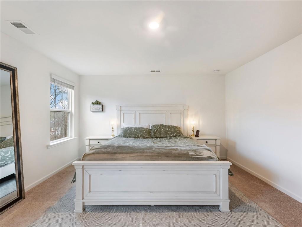 680 Groover Street Ball Ground, GA 30107 - Photo 21 of 42 a bedroom with a bed and a window