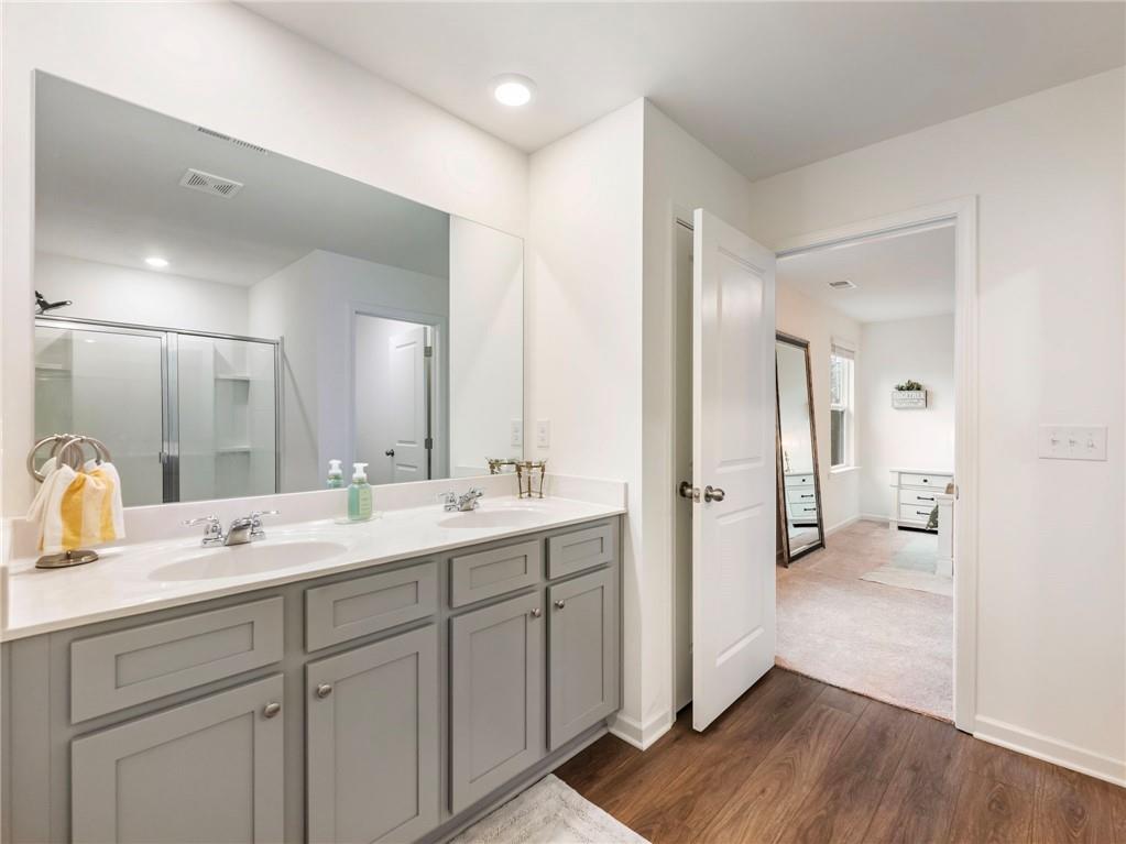 680 Groover Street Ball Ground, GA 30107 - Photo 23 of 42 a en suite bathroom with a double vanity sink double and mirror