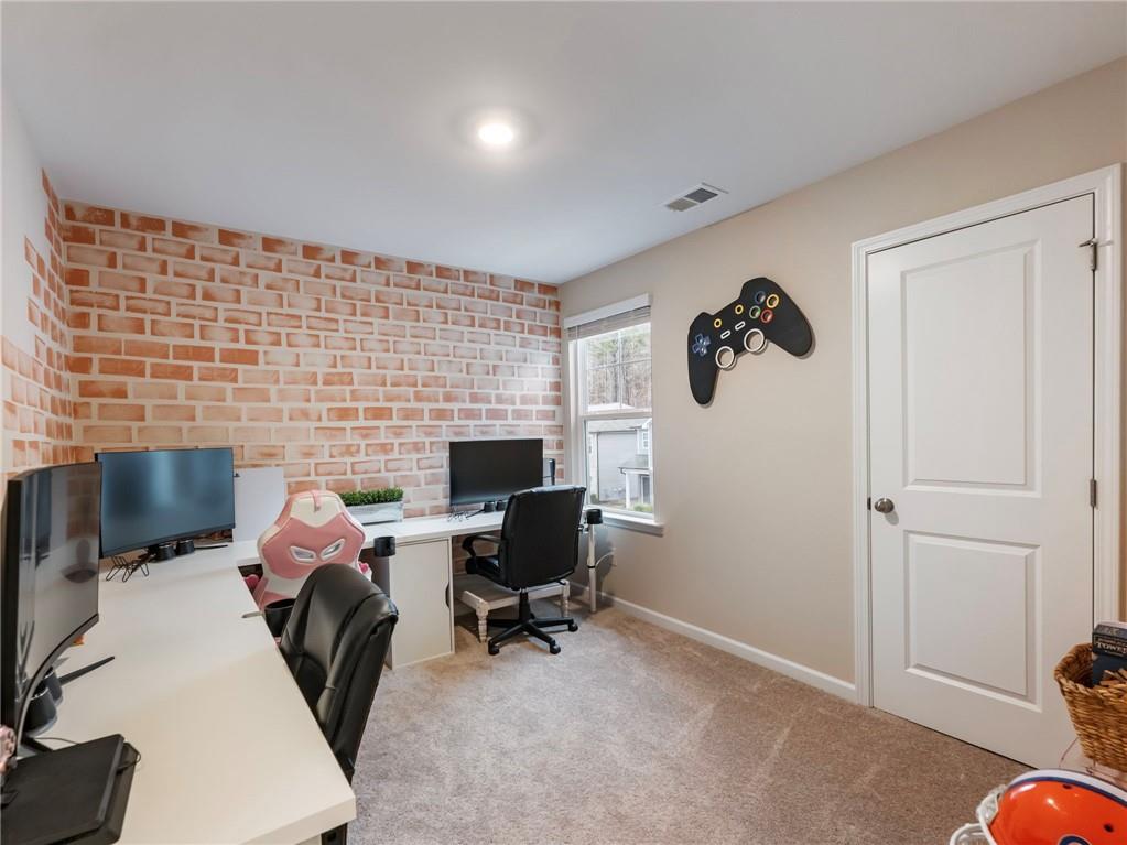 680 Groover Street Ball Ground, GA 30107 - Photo 24 of 42 a work room with furniture and rug