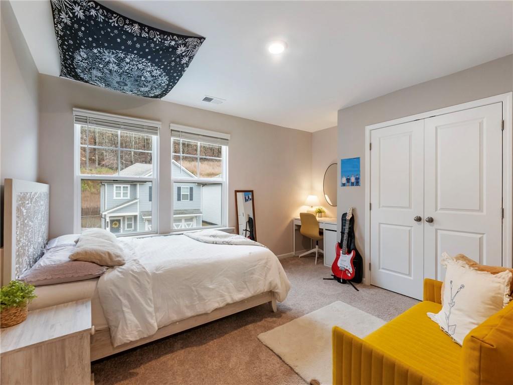 680 Groover Street Ball Ground, GA 30107 - Photo 26 of 42 a bedroom with bed and a window