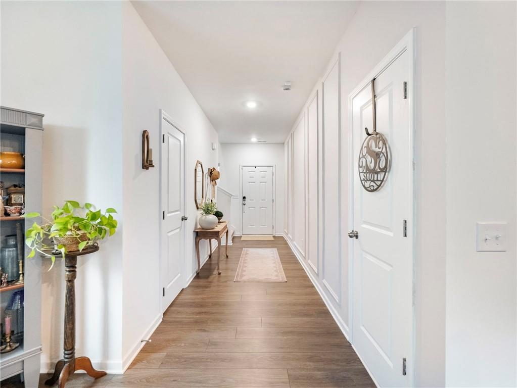680 Groover Street Ball Ground, GA 30107 - Photo 3 of 42 a view of a hallway with wooden floor