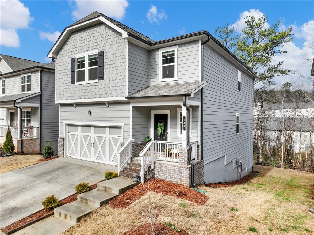 680 Groover Street Ball Ground, GA 30107 - Photo 32 of 42 a view of a house with a yard