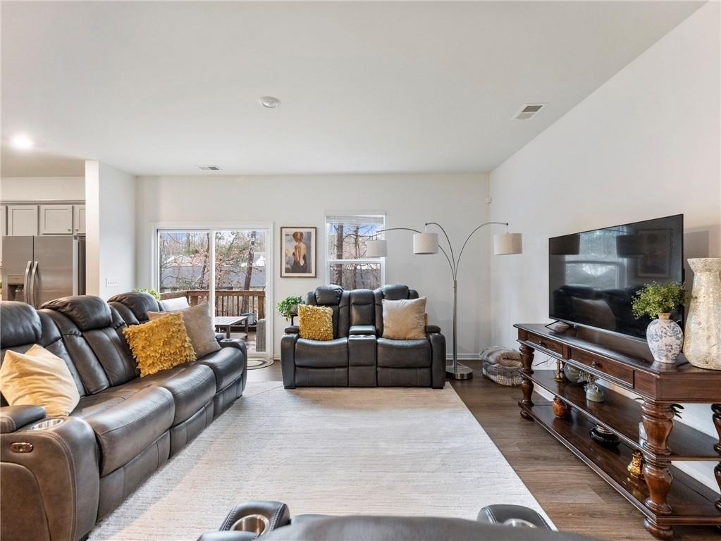 680 Groover Street Ball Ground, GA 30107 - Photo 5 of 42 a living room with furniture and a flat screen tv