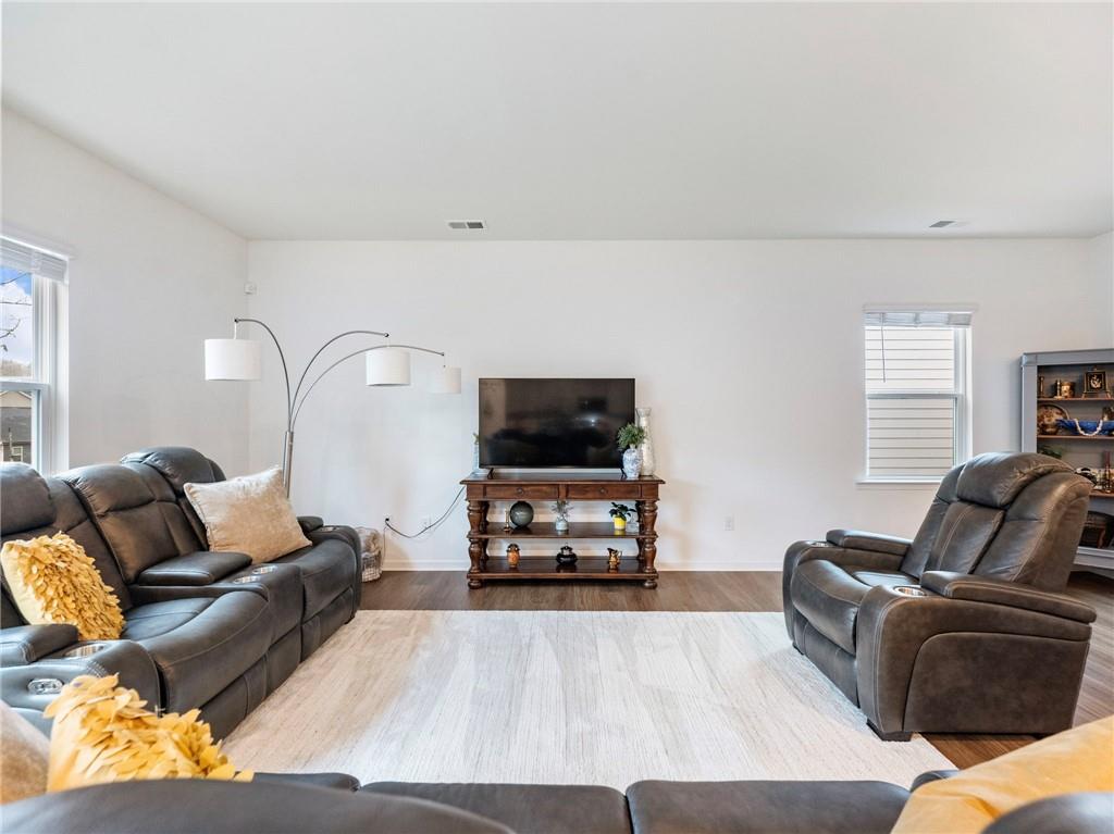680 Groover Street Ball Ground, GA 30107 - Photo 7 of 42 a living room with furniture and a flat screen tv