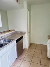 a kitchen with a sink cabinets and utility room