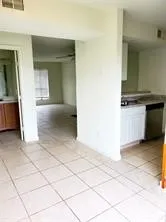 a view of a kitchen with kitchen island granite countertop a refrigerator and a stove