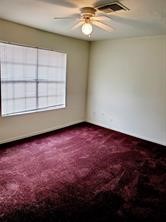 7839 Fuqua Street, Unit 7839 Houston, TX 77075 - Photo 9 of 10 an empty room with a ceiling fan and window