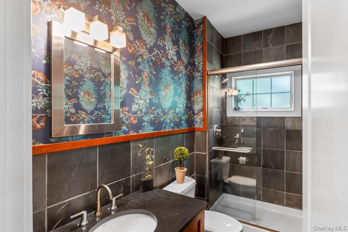 9 Ronwood Road Chestnut Ridge, NY 10977 - Photo 20 of 48 a bathroom with a toilet a sink and mirror