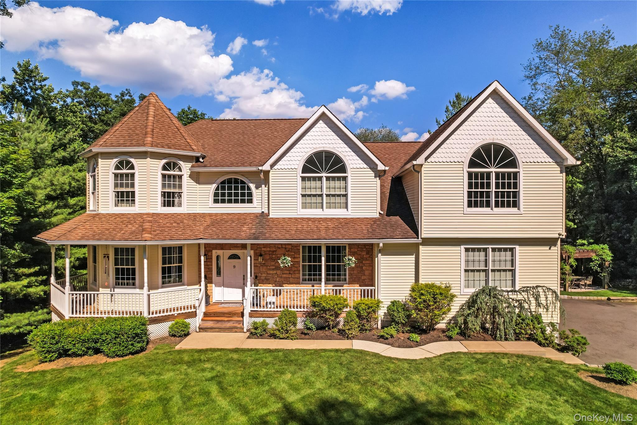 9 Ronwood Road Chestnut Ridge, NY 10977 - Photo 2 of 48 a front view of a house with a yard and porch