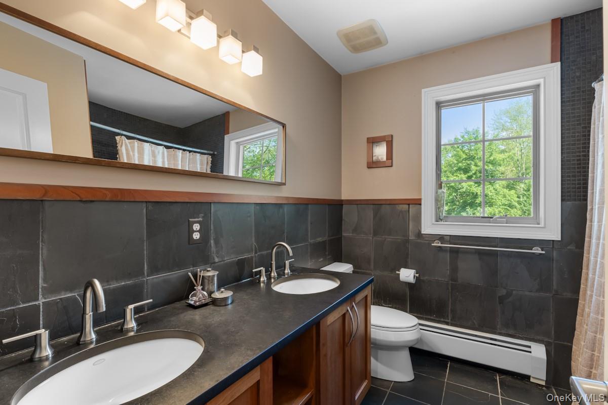 9 Ronwood Road Chestnut Ridge, NY 10977 - Photo 30 of 48 a bathroom with a sink and a mirror