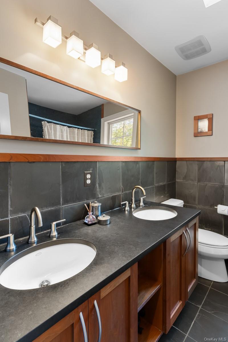 9 Ronwood Road Chestnut Ridge, NY 10977 - Photo 31 of 48 a bathroom with a sink double vanity and a mirror